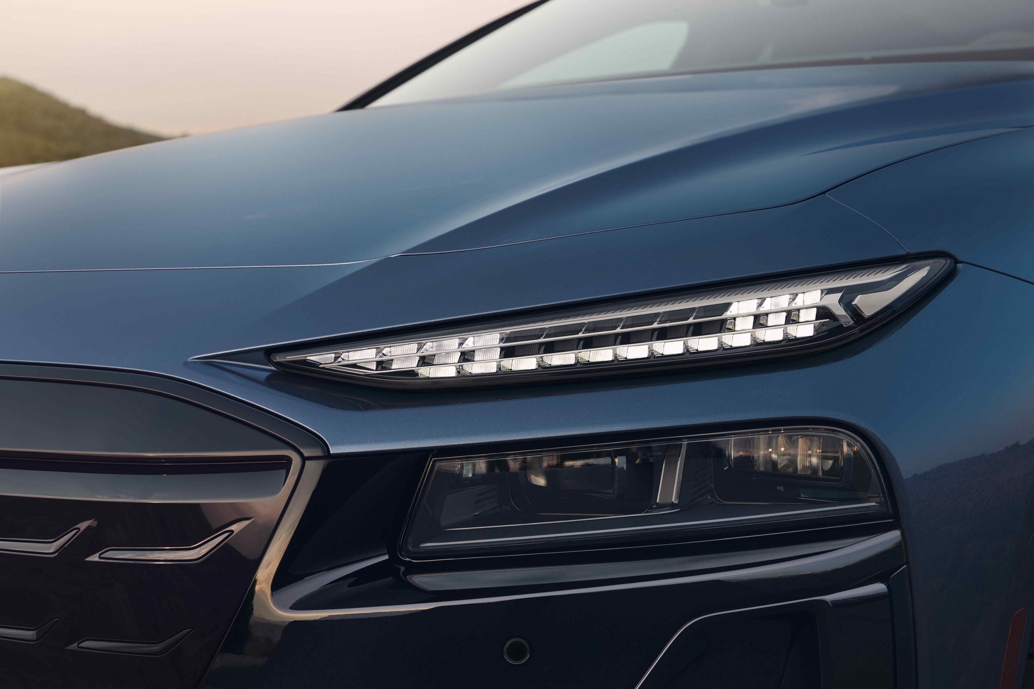 Close shot of an Audi A6 three quarter view headlights.